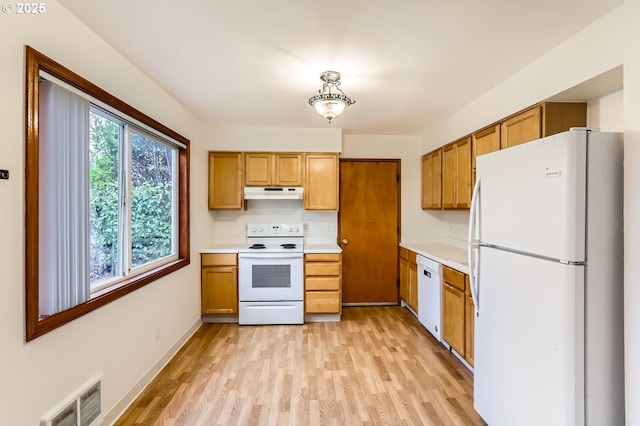 kitchen with white appliances and light wood-type flooring