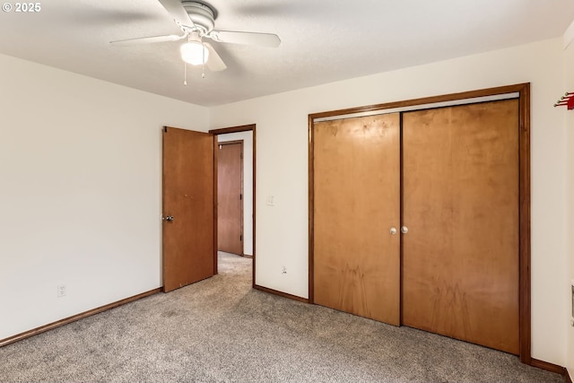 unfurnished bedroom featuring ceiling fan, light colored carpet, and a closet