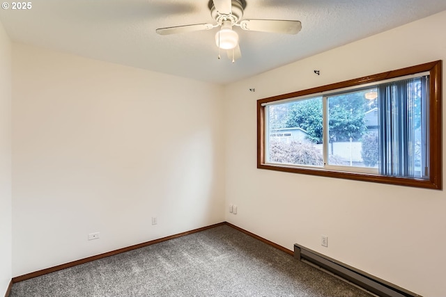 spare room featuring a baseboard heating unit, ceiling fan, and carpet