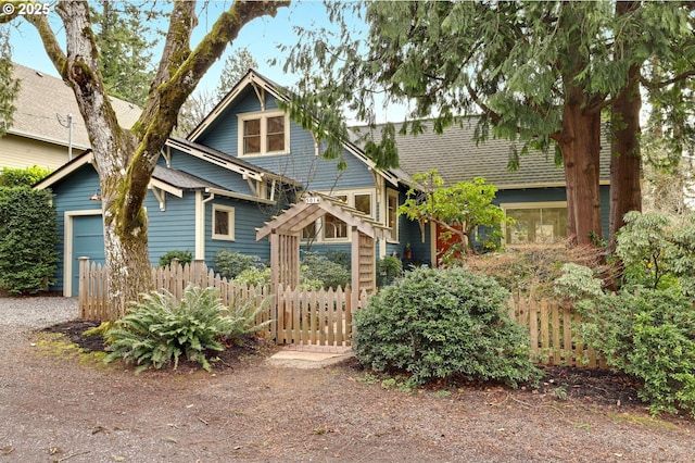 view of front of house featuring fence and an attached garage