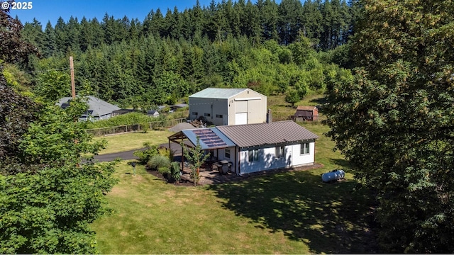 view of subject property with a heavily wooded area