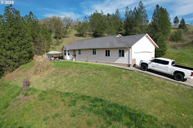 exterior space with a garage, a front yard, and concrete driveway