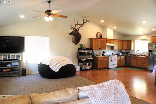 living area featuring vaulted ceiling, recessed lighting, dark wood-type flooring, and a ceiling fan