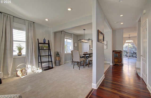 interior space with an inviting chandelier, a wealth of natural light, and baseboards