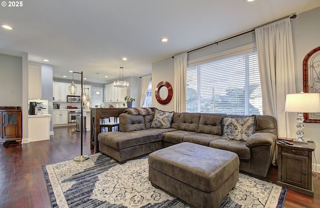 living room featuring recessed lighting, a chandelier, and dark wood-style floors