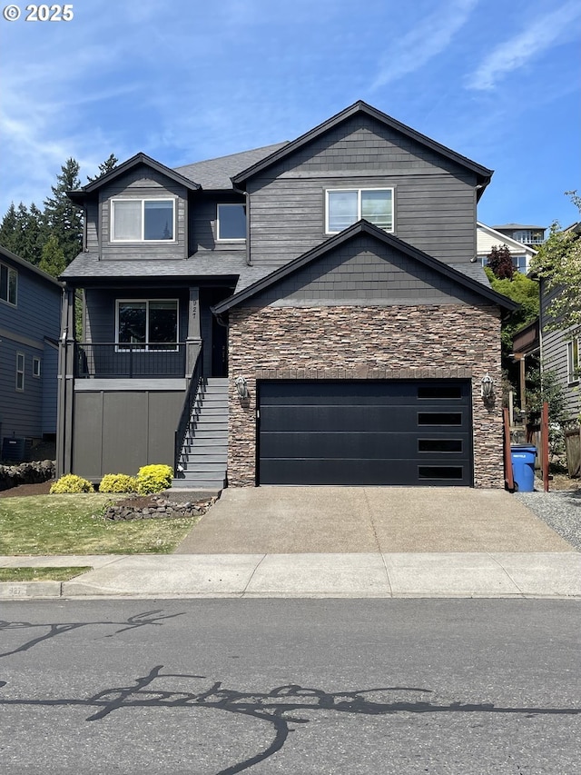 view of front facade with stairway, a garage, stone siding, and driveway