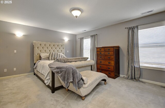 bedroom with light carpet, baseboards, and visible vents