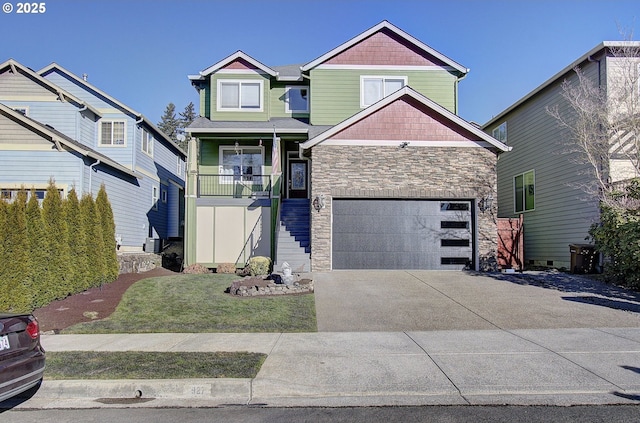 craftsman inspired home with a garage and a front yard