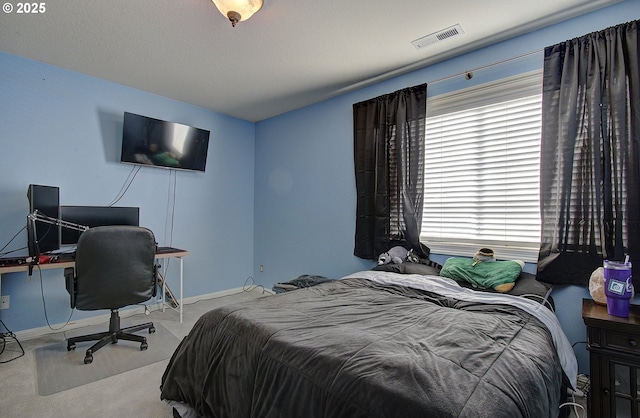 carpeted bedroom with baseboards and visible vents