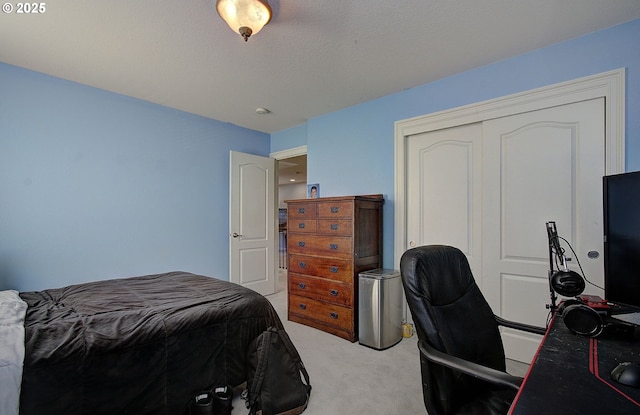 bedroom with light carpet and a closet