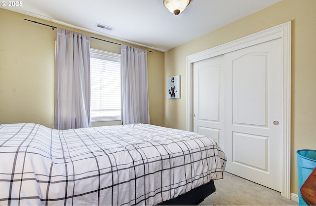 bedroom with light colored carpet and a closet