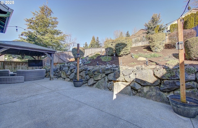 view of patio / terrace with outdoor lounge area, a gazebo, and a fenced backyard