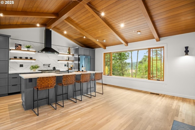 2390 Southshore Blvd, Lake Oswego, OR 97034 - kitchen with wall chimney exhaust hood, open shelves, gray cabinetry, high quality fridge, and light countertops