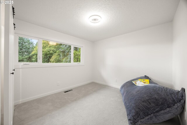 2390 Southshore Blvd, Lake Oswego, OR 97034 - bedroom featuring light carpet and a textured ceiling