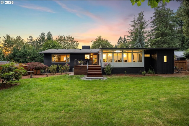 2390 Southshore Blvd, Lake Oswego, OR 97034 - back of property at dusk featuring a wooden deck, a chimney, stairway, and a sunroom