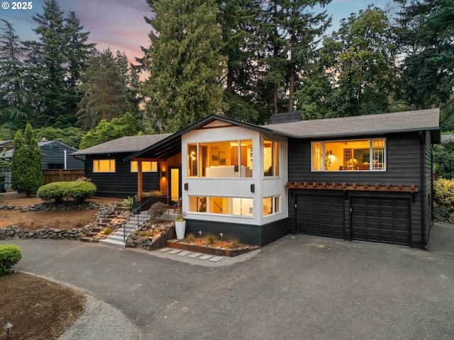 2390 Southshore Blvd, Lake Oswego, OR 97034 - view of front of house featuring driveway, a garage, and a chimney