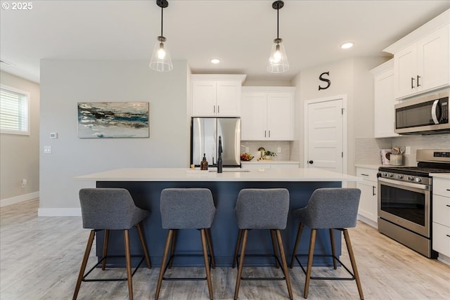 209 W Barbaras Way, Newberg, OR 97132 - kitchen featuring appliances with stainless steel finishes, a kitchen island, backsplash, white cabinetry, and recessed lighting