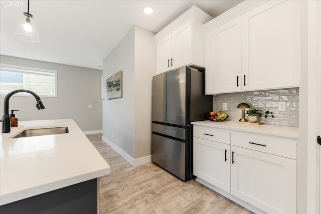 209 W Barbaras Way, Newberg, OR 97132 - kitchen with freestanding refrigerator, decorative backsplash, light wood-type flooring, recessed lighting, and white cabinets