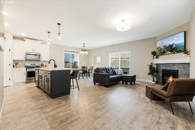 209 W Barbaras Way, Newberg, OR 97132 - kitchen featuring stainless steel appliances, open floor plan, light countertops, a kitchen bar, and white cabinetry