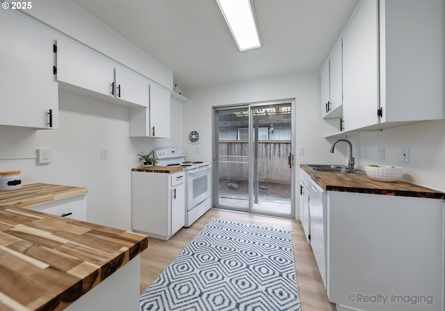 kitchen featuring white electric range oven, sink, white cabinetry, wooden counters, and light wood-type flooring