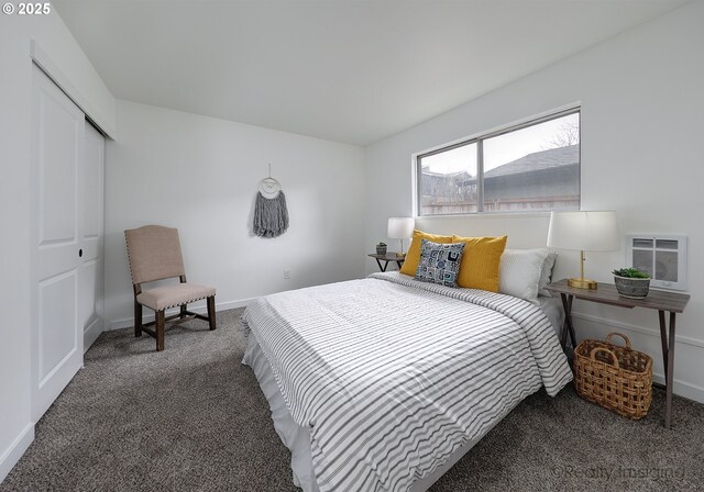 bedroom featuring heating unit, dark carpet, and a closet