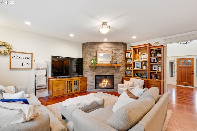 15475 SW Brighton Way, Beaverton, OR 97007 - living room featuring light wood finished floors, a stone fireplace, and recessed lighting