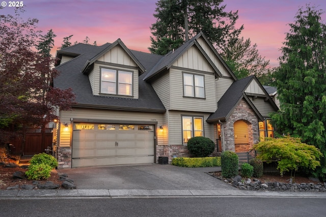 15475 SW Brighton Way, Beaverton, OR 97007 - craftsman inspired home featuring stone siding, board and batten siding, an attached garage, and asphalt driveway