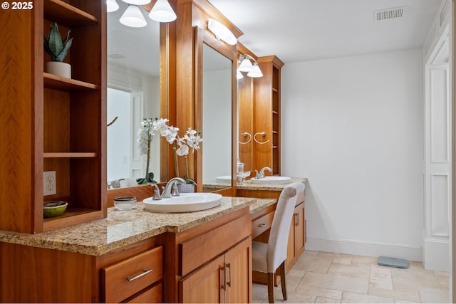 15475 SW Brighton Way, Beaverton, OR 97007 - full bathroom featuring two vanities, baseboards, and stone finish flooring