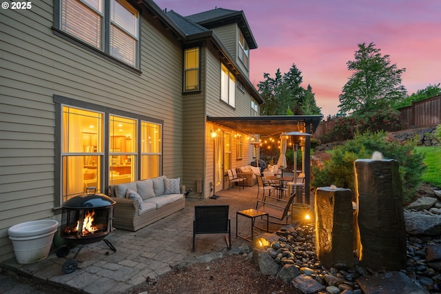 15475 SW Brighton Way, Beaverton, OR 97007 - patio terrace at dusk with an outdoor living space with a fire pit and a patio area