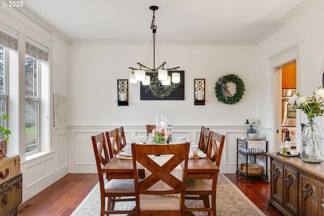 15475 SW Brighton Way, Beaverton, OR 97007 - dining area featuring dark wood finished floors, a chandelier, wainscoting, and a decorative wall