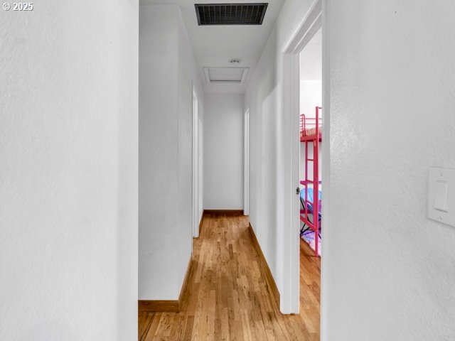 3185 14th Ave, Albany, OR 97322 - hallway featuring attic access and light wood-type flooring