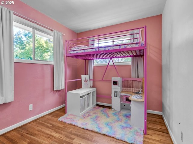 3185 14th Ave, Albany, OR 97322 - unfurnished bedroom featuring wood finished floors and baseboards