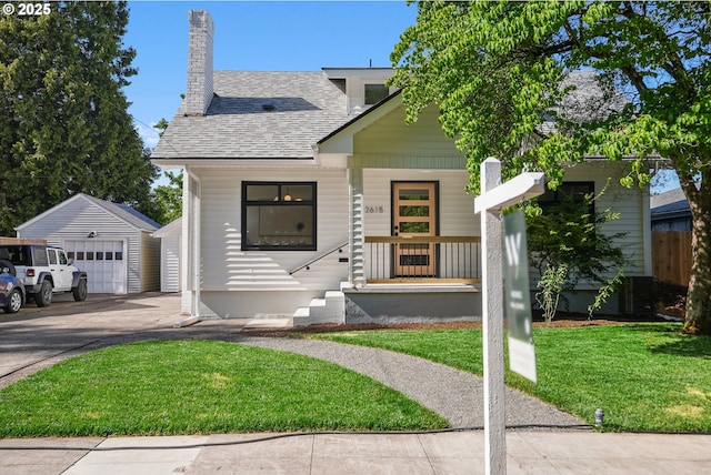 2615 N Gammans Pl, Portland, OR 97217 - view of front of home with an outbuilding, roof with shingles, a front yard, driveway, and a chimney