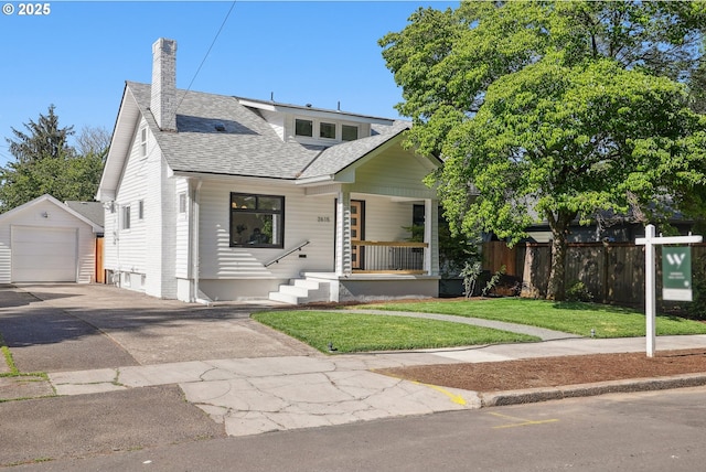 2615 N Gammans Pl, Portland, OR 97217 - bungalow featuring asphalt driveway, an outdoor structure, a porch, roof with shingles, and a detached garage