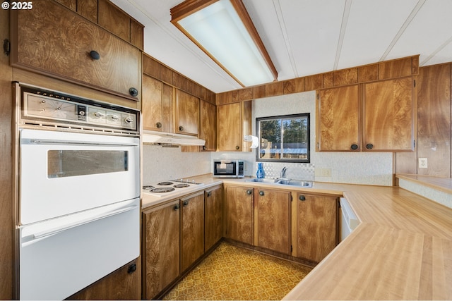 kitchen featuring sink and white appliances