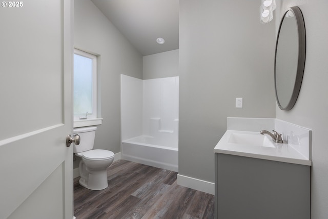 full bathroom featuring vanity, hardwood / wood-style flooring, bathing tub / shower combination, and toilet