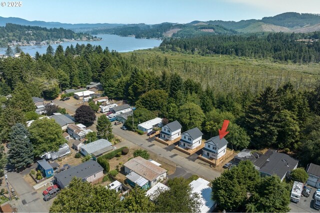 birds eye view of property featuring a water and mountain view