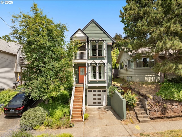 4113 SE Rural St, Portland, OR 97202 - victorian-style house with concrete driveway, a balcony, stairs, and a garage