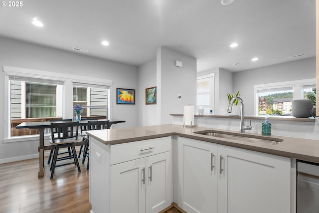 11465 SE Pleasant Valley Pkwy, Happy Valley, OR 97086 - kitchen featuring a sink, dishwasher, recessed lighting, white cabinetry, and wood finished floors