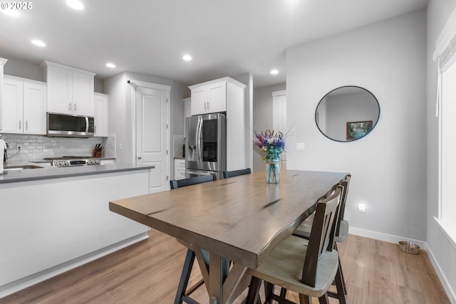 11465 SE Pleasant Valley Pkwy, Happy Valley, OR 97086 - dining area featuring light wood finished floors, recessed lighting, and baseboards