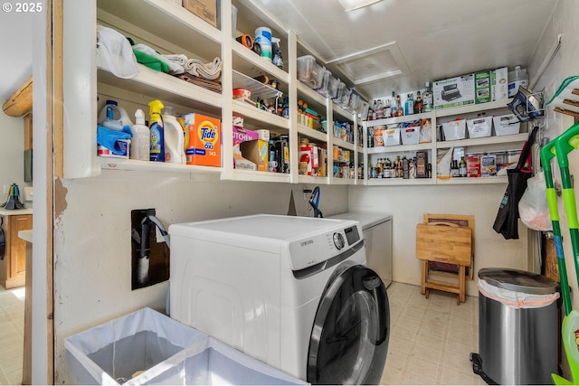 laundry room featuring independent washer and dryer, tile patterned floors, and attic access