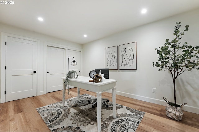 home office featuring recessed lighting, light wood-style floors, and baseboards