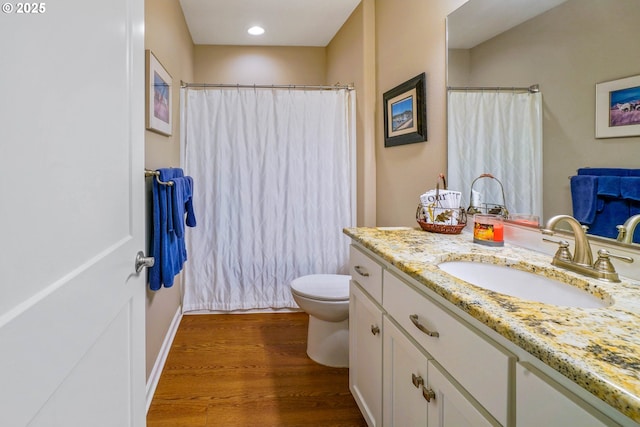 bathroom with vanity, hardwood / wood-style floors, and toilet