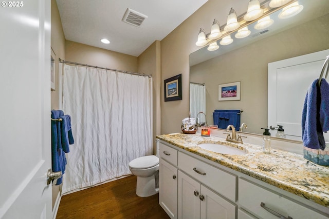 bathroom with hardwood / wood-style flooring, vanity, and toilet