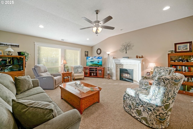 carpeted living room featuring lofted ceiling, ceiling fan, and a textured ceiling