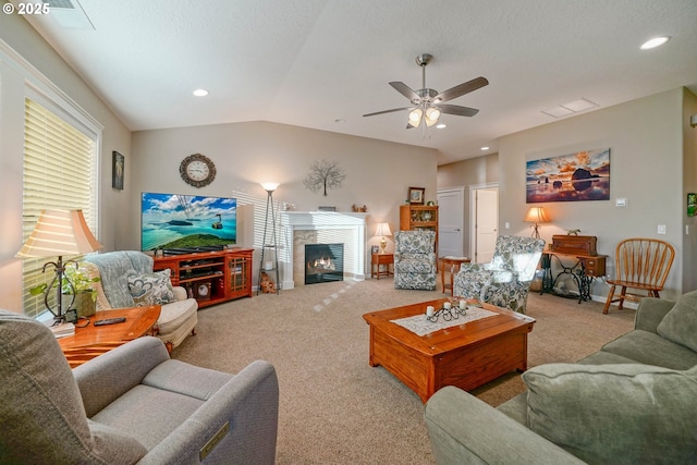 carpeted living room featuring ceiling fan, lofted ceiling, and a textured ceiling