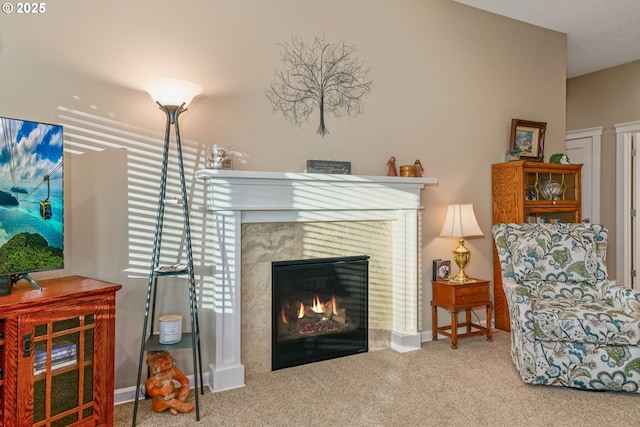 carpeted living room featuring a tile fireplace