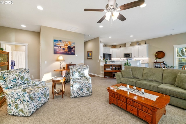 living room with light colored carpet and ceiling fan