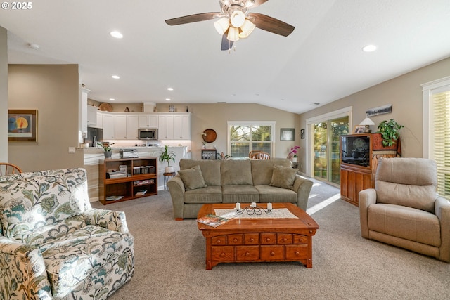 carpeted living room featuring ceiling fan and lofted ceiling