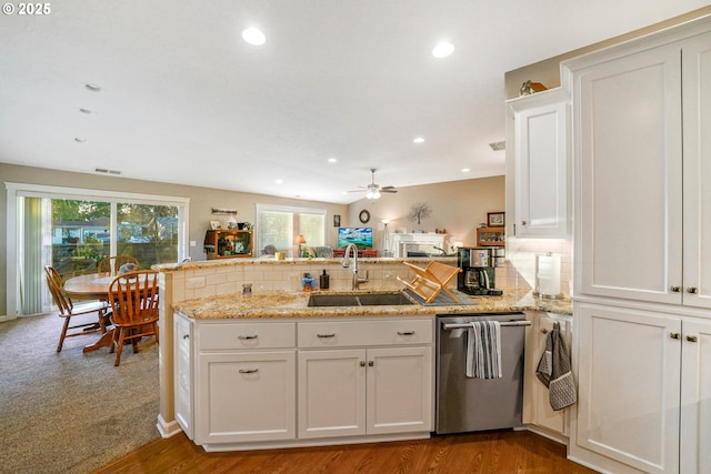 kitchen with white cabinetry, kitchen peninsula, sink, and dishwasher